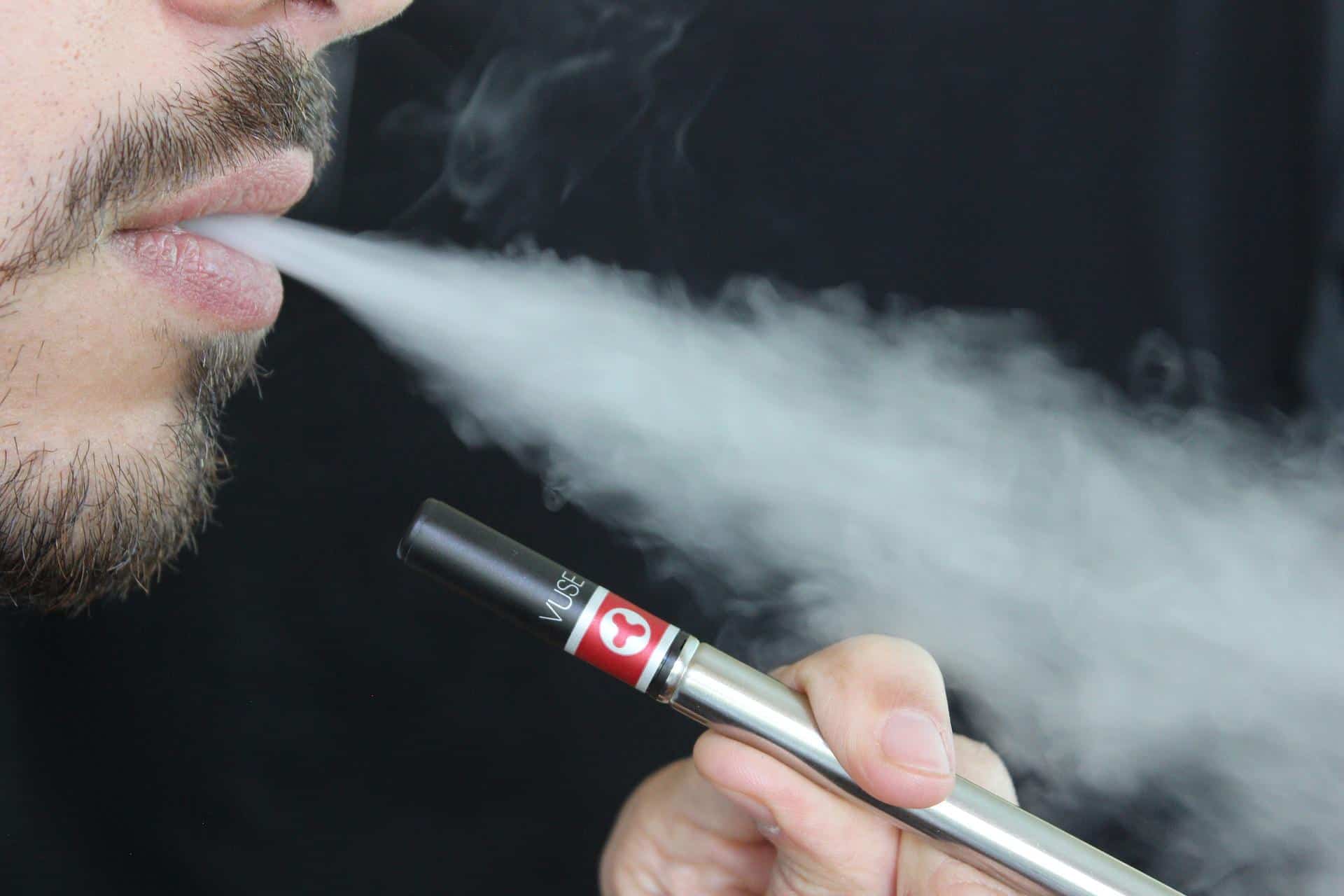 A man blowing smoke from an e-cigarette