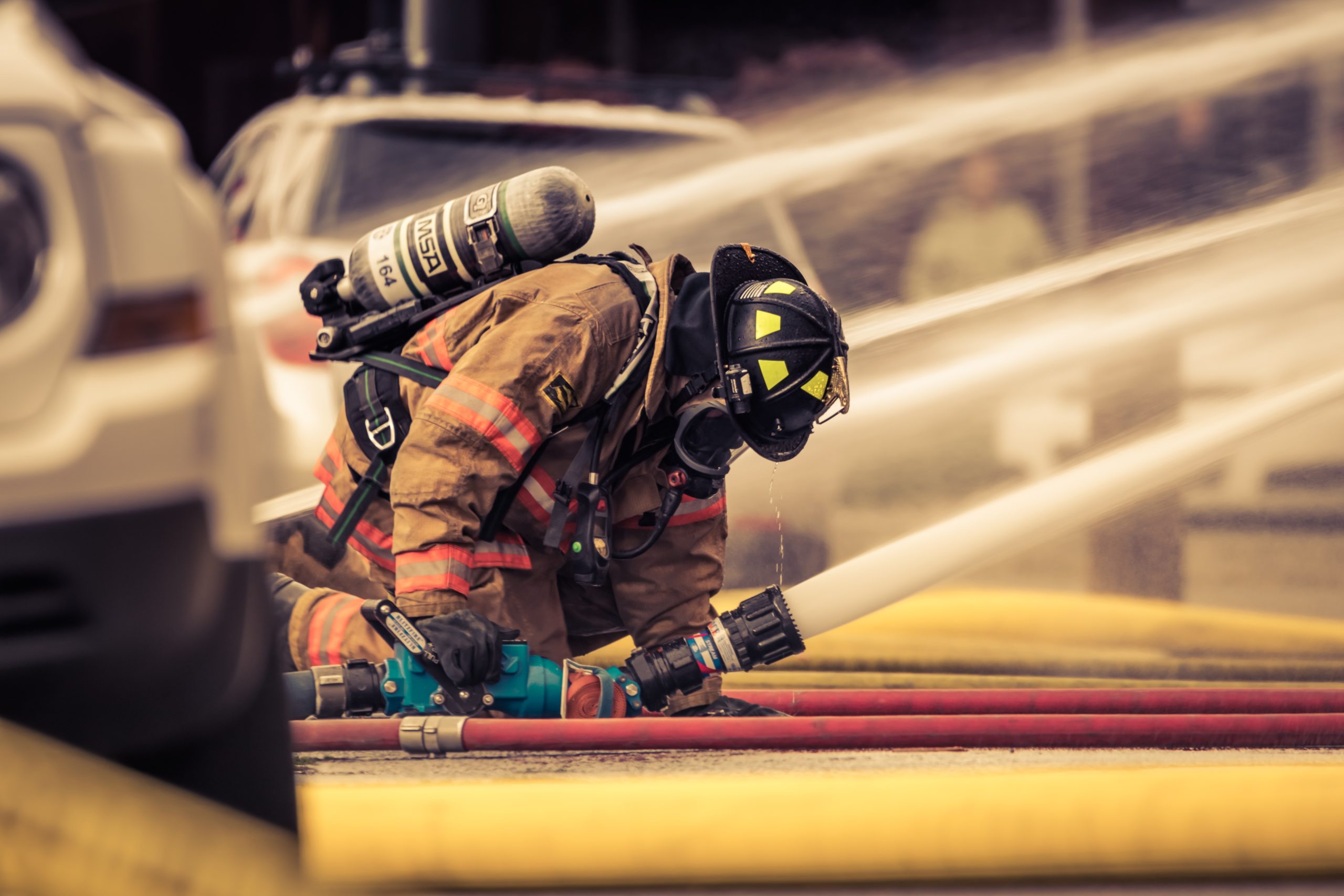 A firefighter spraying a hose