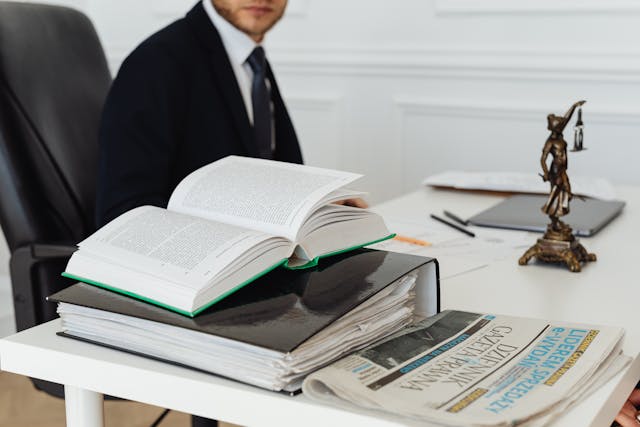 a lawyer's table in a law firm with record papers and a figure of justice