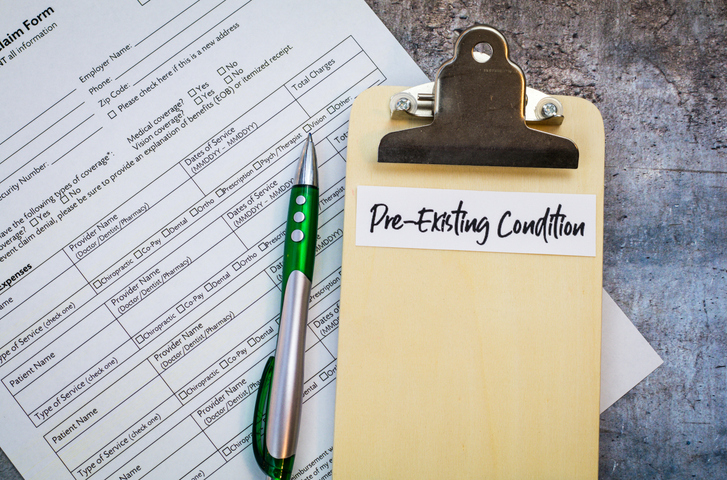Pre-Existing Condition healthcare concept with pills and money and forms and clipboards, flat lay