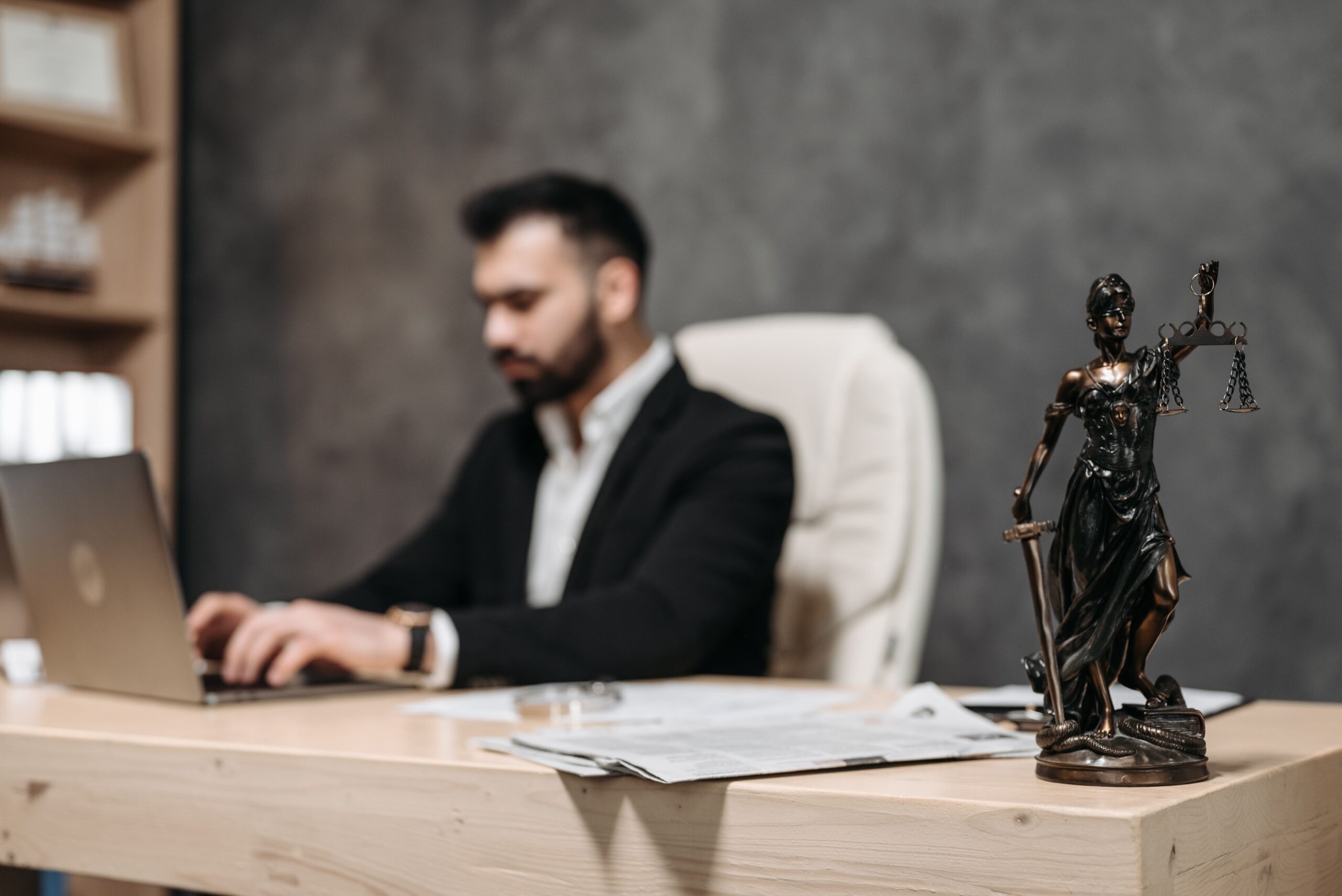 man in suit on a computer