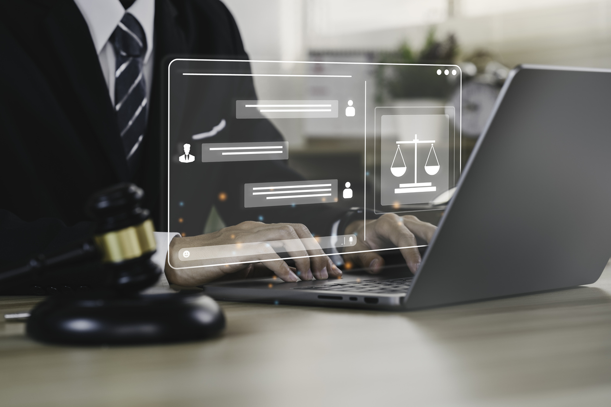 Hand of the businessman or Lawyer with legal services icon on the laptop screen for Legal advice online in Labor law for a business company legal. concept of legal consultant and lawyer