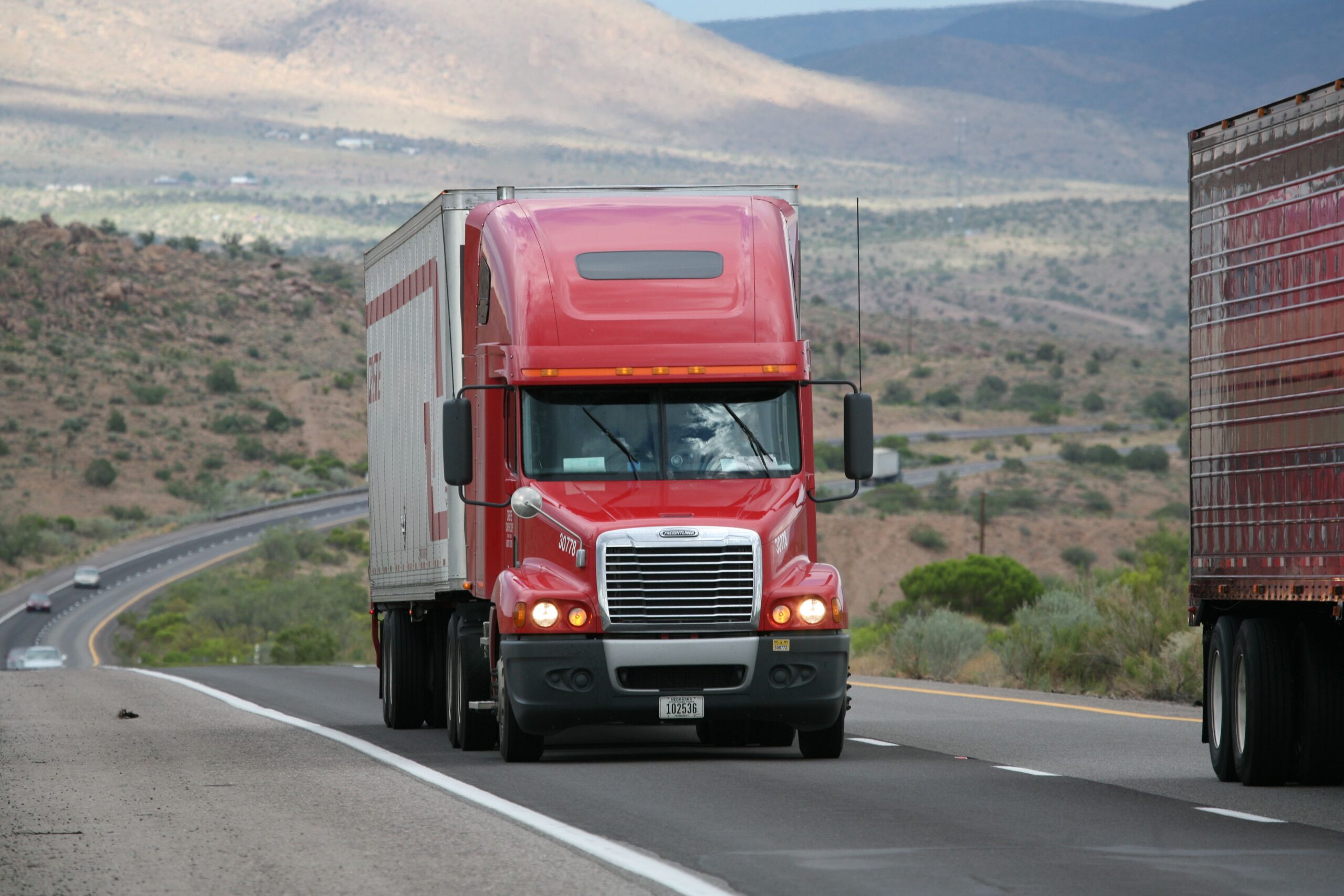 heavy commercial truck driving down road