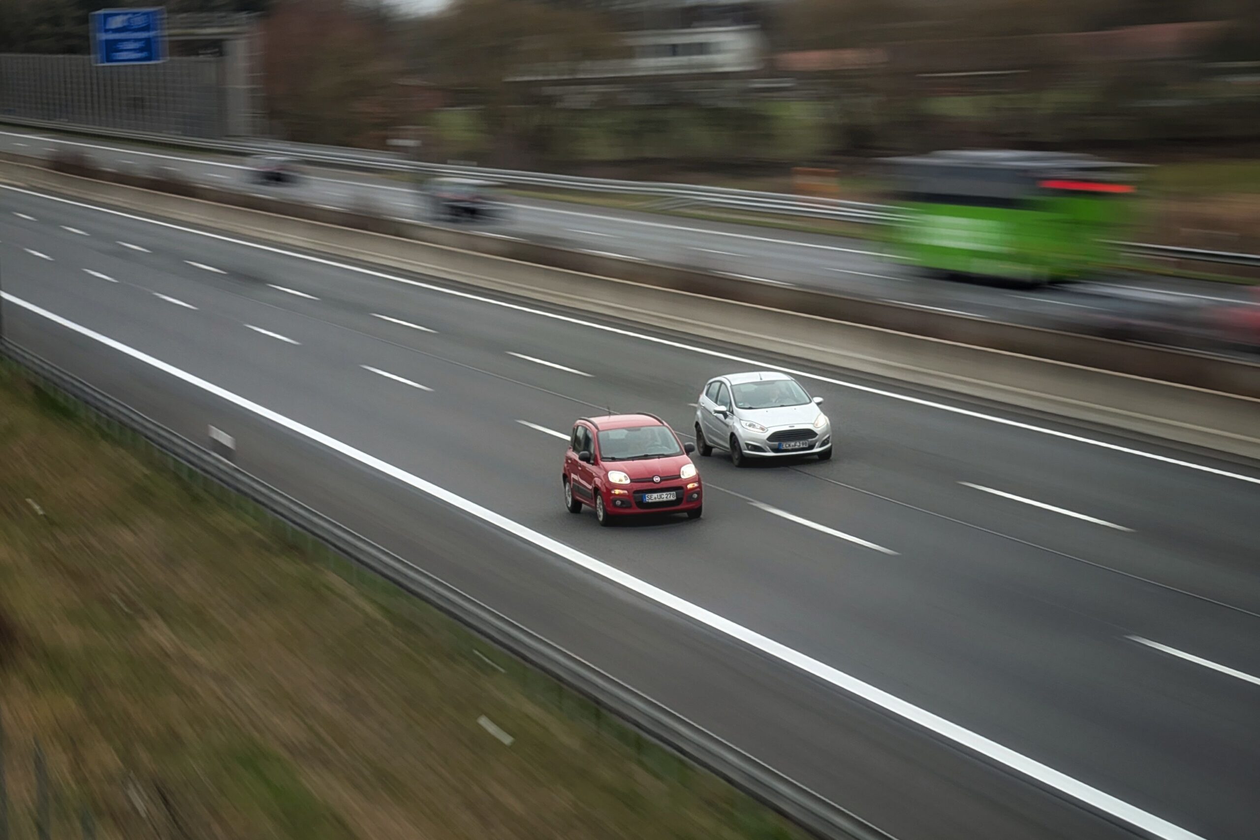two cars driving down highway
